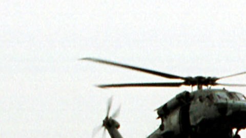 As Thick Gray Clouds Hang Overhead The Air An Hs 60 Seahawk Flies Around The USS Anzio As The U S F