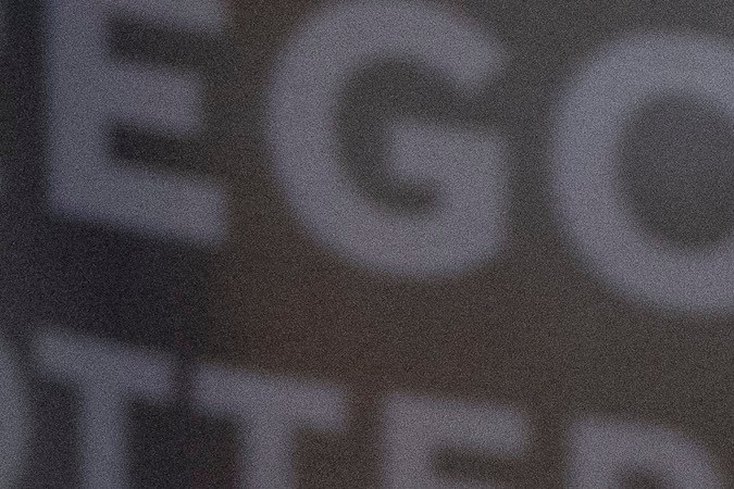 Cheng "Charlie" Saephan señala su banda que dice "Iu-Mien USA" mostrando su herencia de Laos.