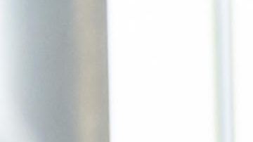 Latin American couple looking at cars at the dealership and talking to the salesman - business concepts