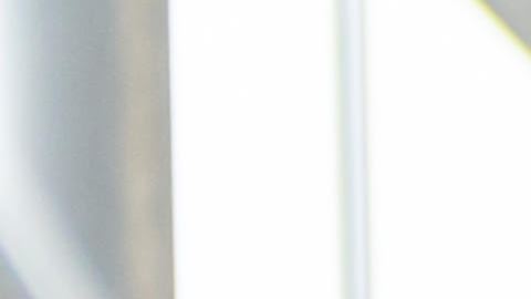 Latin American couple looking at cars at the dealership and talking to the salesman - business concepts