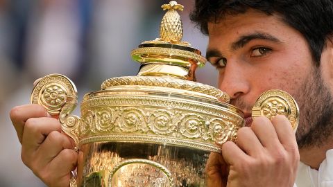 Spain's Carlos Alcaraz celebrates with the trophy after beating Serbia's Novak Djokovic to win the final of the men's singles on day fourteen of the Wimbledon tennis championships in London, Sunday, July 16, 2023. (AP Photo/Kirsty Wigglesworth)