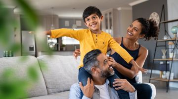 Cheerful,Indian,Son,Sitting,On,Father,Shoulder,Playing,At,Home