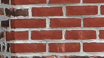 A woman looks out from her apartment window on a hot summer day, Tuesday, July 11, 2017, in the Bronx borough of New York. (AP Photo/Mark Lennihan)