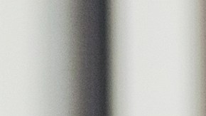 Mid adult female bank employee discusses a mobile banking app's features with a mature female client.