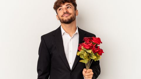 Young,Arab,Man,Holding,Bouquet,Of,Roses,Isolated,On,White