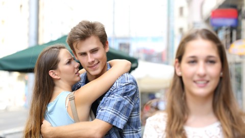 Unfaithful,Man,Hugging,His,Girlfriend,While,Is,Looking,Another,One