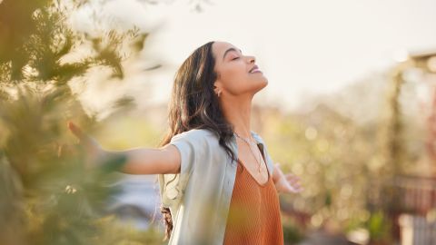 Young,Latin,Woman,With,Arms,Outstretched,Breathing,In,Fresh,Air