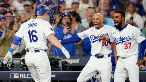 Will Smith celebra un jonrón de Dodgers junto a Mookie Betts (C) y Teóscar Hernández (R).