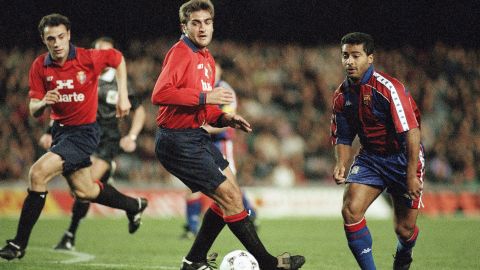 Barcelona's Brazilian striker Romario (r) gets the better of Jose Mari Garcia of Osasuna in a first division soccer match on Saturday, Feb. 19, 1994 in Barcelona. Romario went on to score three goals as Barcelona hit form in an impressive 8-1 victory. (AP Photo/Amilcar de Leon)