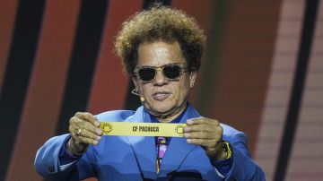 Romero Brito muestra el nombre del Club de Fútbol Pachuca durante la ceremonia de los bombos en el sorteo del Mundial de Clubes.