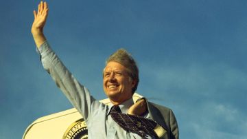 Una foto proporcionada por la Biblioteca Jimmy Carter muestra al expresidente estadounidense Jimmy Carter saludando en lo alto de los escalones del Air Force One antes de partir hacia Los Ángeles para hablar en la convención de United Auto Workers, el 17 de mayo de 1977 (reeditada el 29 de diciembre de 2024).