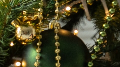 Happy,,Dreamy,,Curly-haired,Black-haired,Woman,Sits,Near,The,Christmas,Tree,