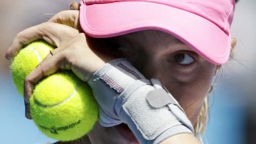 Lucie Hradecka of the Czech Republic holds the ball between plays during their third round match against Julia Goerges of Germany at the Australian Open tennis championship in Melbourne, Australia, Friday, Jan. 23, 2015. (AP Photo/Bernat Armangue)