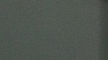 Happy Latin American couple at home paying bills online on their laptop and smiling - financial technology concepts