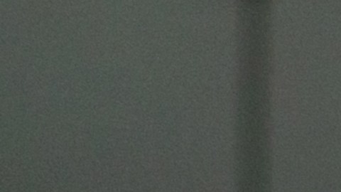 Happy Latin American couple at home paying bills online on their laptop and smiling - financial technology concepts