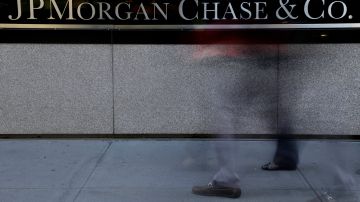 FILE - The JPMorgan Chase & Co. logo is displayed at their headquarters in New York, in this Monday, Oct. 21, 2013, file photo. A person close to the talks says the Justice Department and JPMorgan Chase & Co. have reached agreement on all issues in a $13 billion settlement of a civil inquiry into the company's sales of low-quality mortgage-backed securities that collapsed in value in the financial crisis. (AP Photo/Seth Wenig, File)