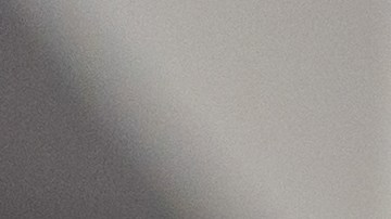 Latin American senior woman at home holding a package and checking an app on her cell phone - lifestyle concepts