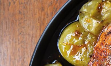 Muslos de pollo con piel crujiente bañados en aderezo de chile guajillo y acompañados de tomatillos asados al punto exacto de caramelización.
