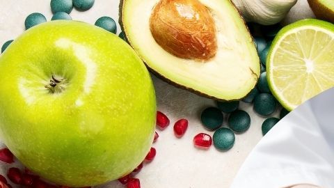 Imagen de pancreas sntenido por un doctor rodeado de juegos verdes y vegetales.