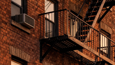edificio de apartamentos en El Bronx o Queens, con un enfoque en las escaleras de incendio icónicas de la ciudad