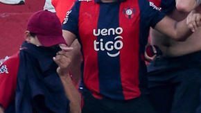 Fotografía cedida por Derlis Martínez que muestra a aficionados de Cerro Porteño enfrentándose con la Policía de Paraguay durante el juego entre Olimpia y Cerro Porteño este domingo, en el estadio Defensores del Chaco, en Asunción.