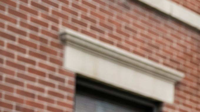 Familia latina frente a un edificio de apartamentos en Nueva York revisando opciones de alquiler, reflejando la dificultad para acceder a vivienda asequible.